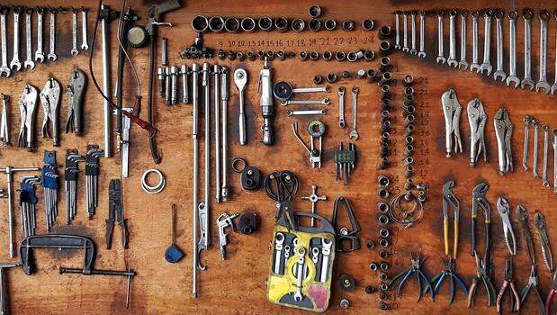 many different sizes of tools wrenches and pliers hanging on wooden panel background tool and object for fixing maintenance or repair car machine or motorcycle concept free photo